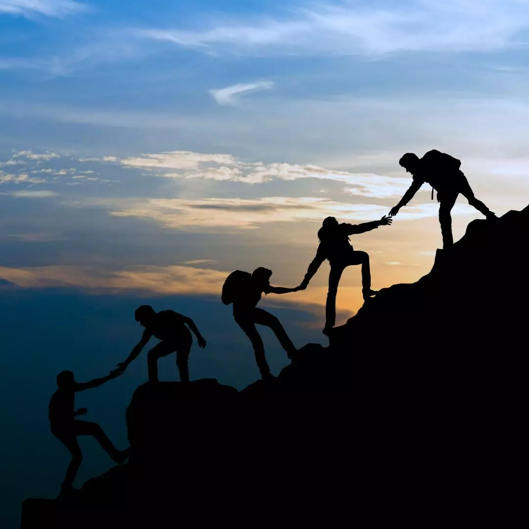 hikers climbing a mountain representing Quickpay Funding is on a mission to empower businesses with the financial resources they need to thrive