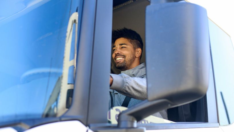 happy truck driver taking control of his cash flow with Quickpay's freight factoring for trucking companies
